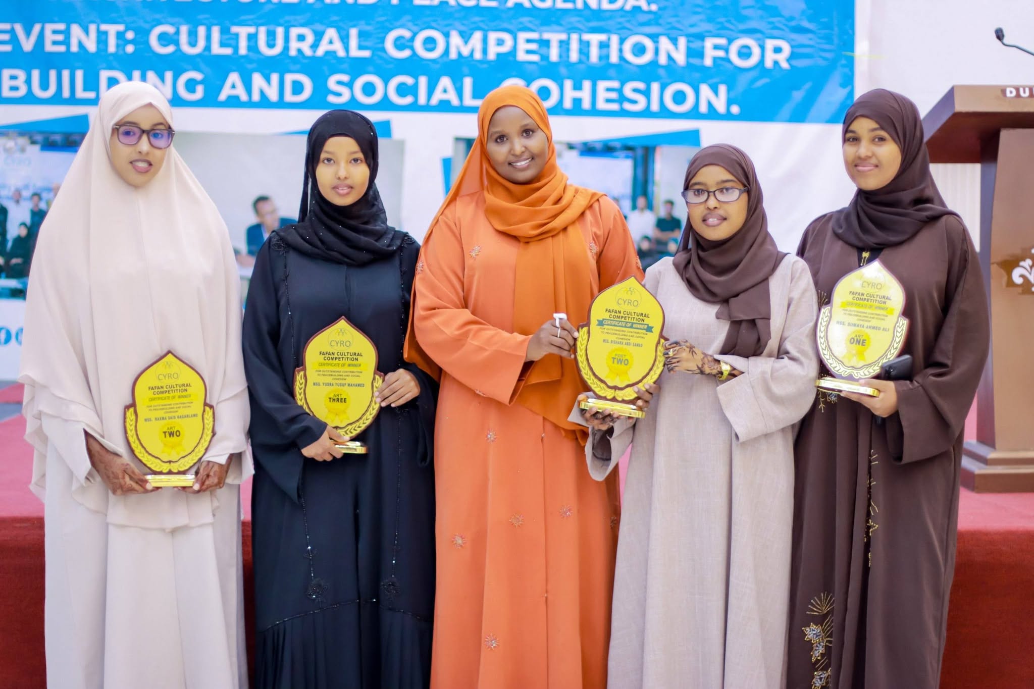 Young women winners holding their trophies