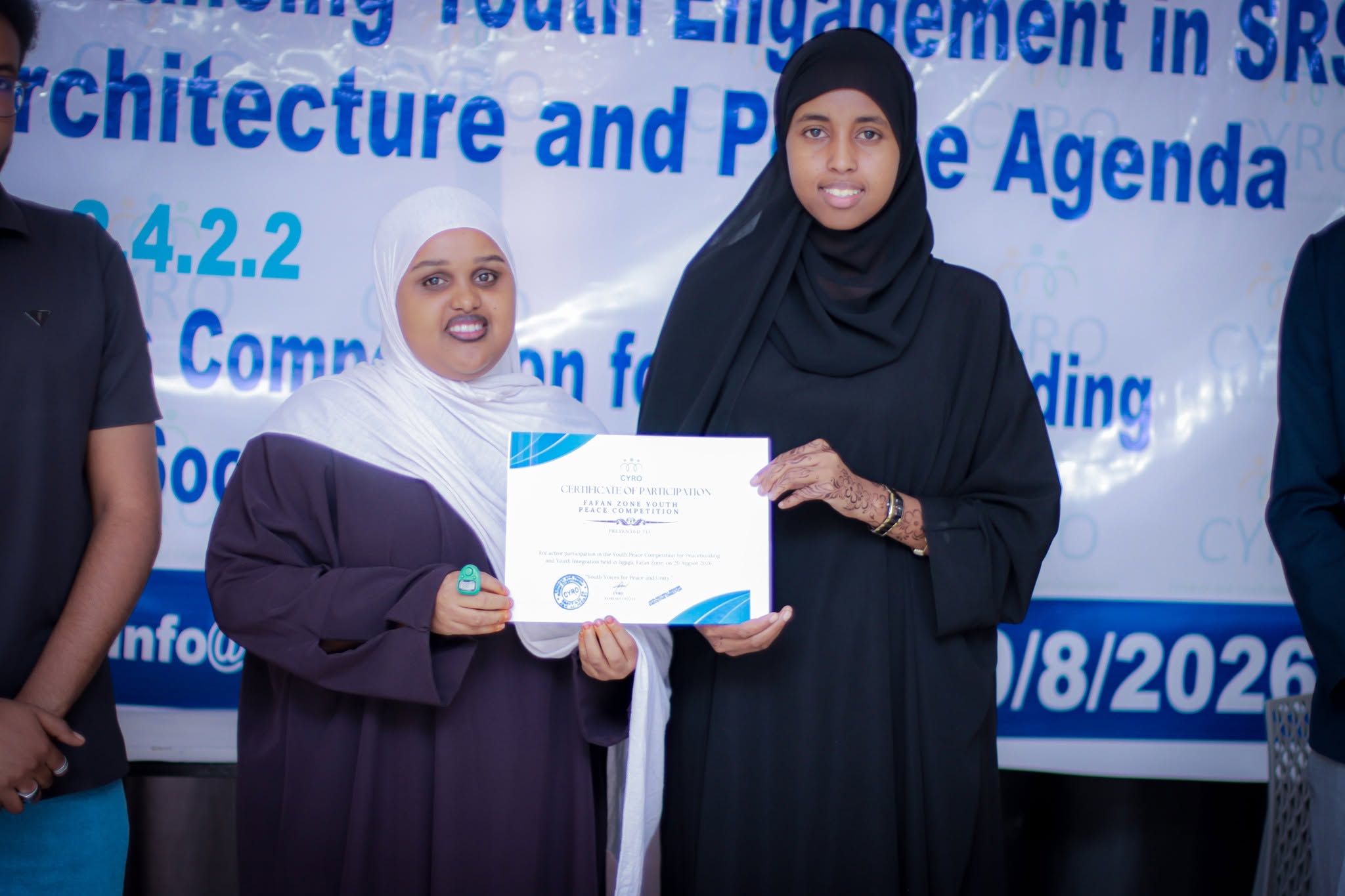 A participant receiving her certificate of participation